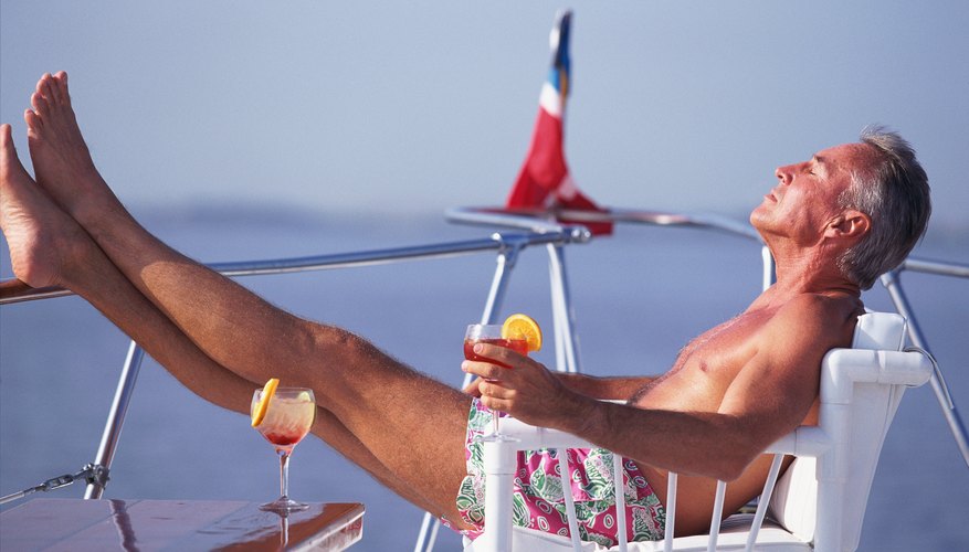 Mature man reclining in deck chair on boat