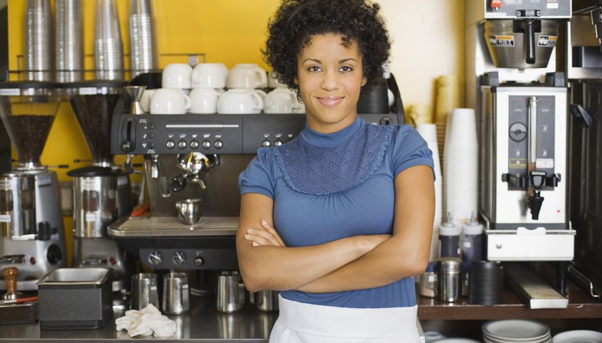 Woman standing beside espresso machine
