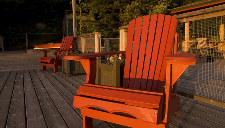 Photo Credit: Design Pics/Design Pics/Getty Images An adirondack chair on a garden patio at sunset.