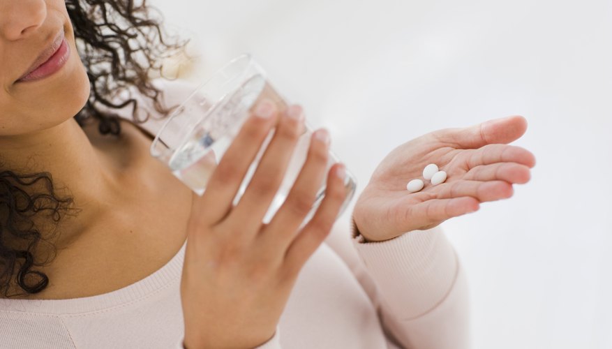 woman taking pills woman taking pills