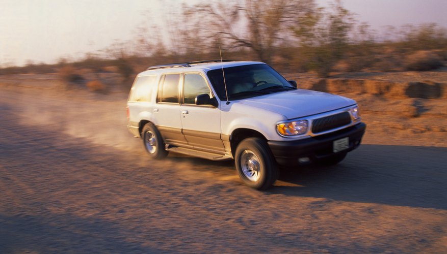 SUV driving on dirt road