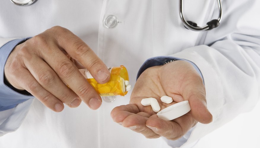 Doctor pouring medicine in hand Doctor pouring medicine in hand