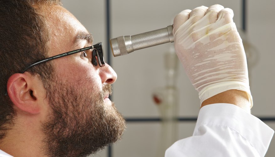 Photo Credit: Tanuki Photography/iStock/Getty Images Chemist using a refractometer.