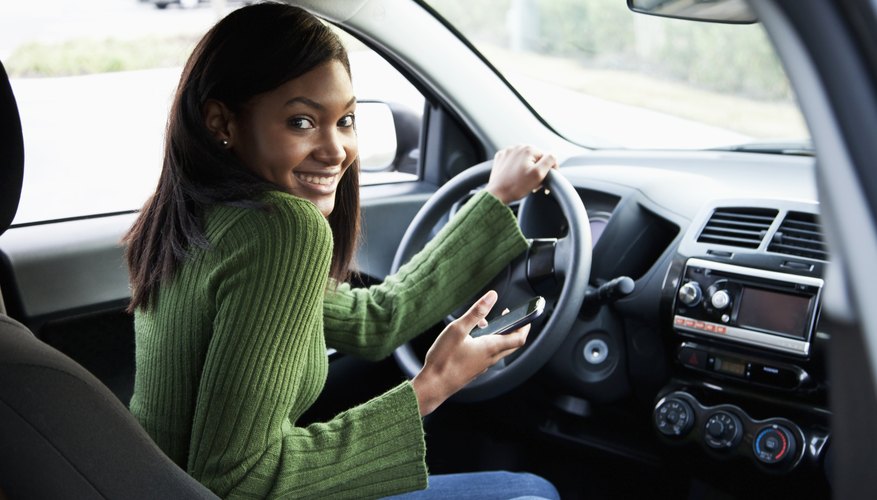 Young teenage driver behind the wheel of a parked car Young teenage driver behind the wheel of a parked car