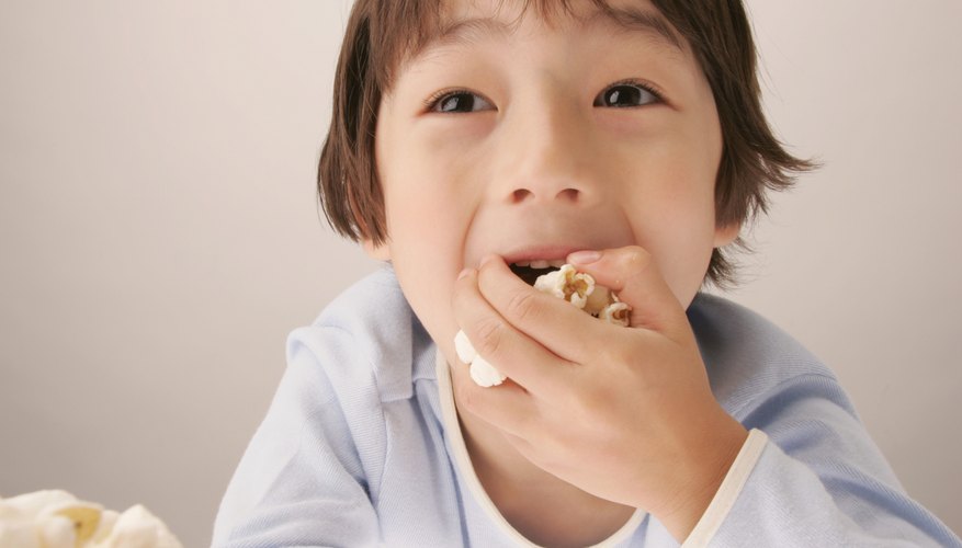 Photo Credit: White Rock/amana images/Getty Images Young boy eating popcorn