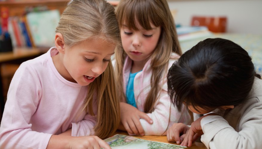 School children reading a book School children reading a book