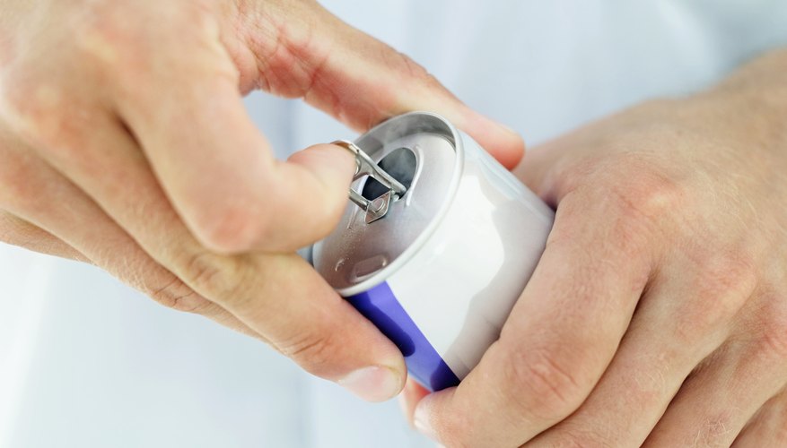 Close-up of a man's hands opening a soft drink can