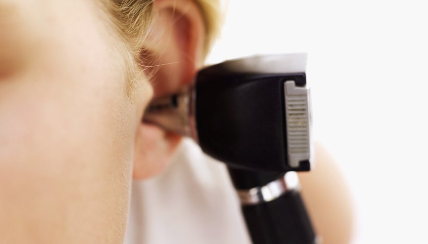 Doctor looking in patients ear Doctor looking in patients ear