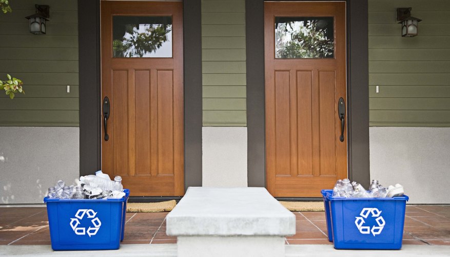 Photo Credit: Jupiterimages/Brand X Pictures/Getty Images Recycling bins sit outside two homes.