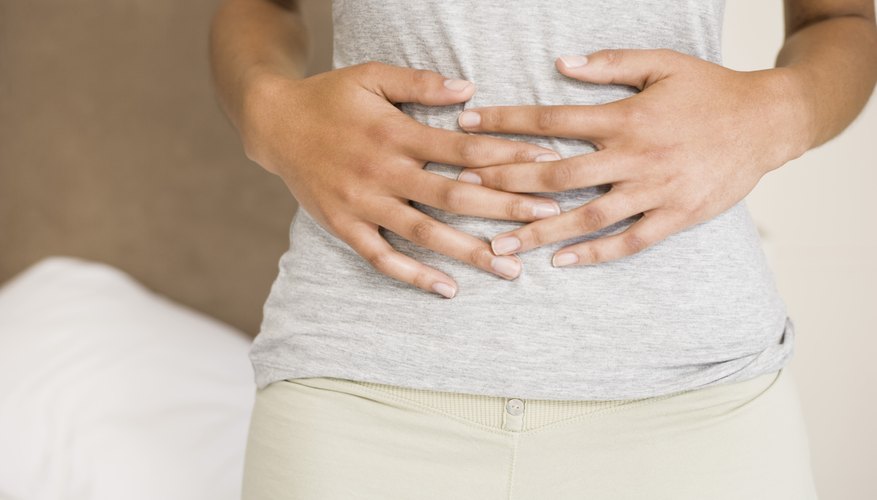 Woman holding abdomen Woman holding abdomen