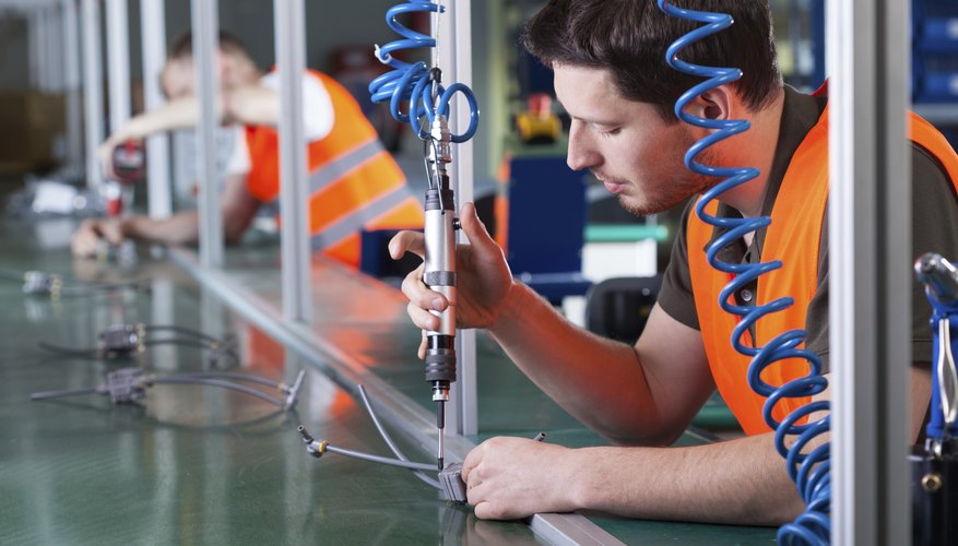 Men during precision work on production line
