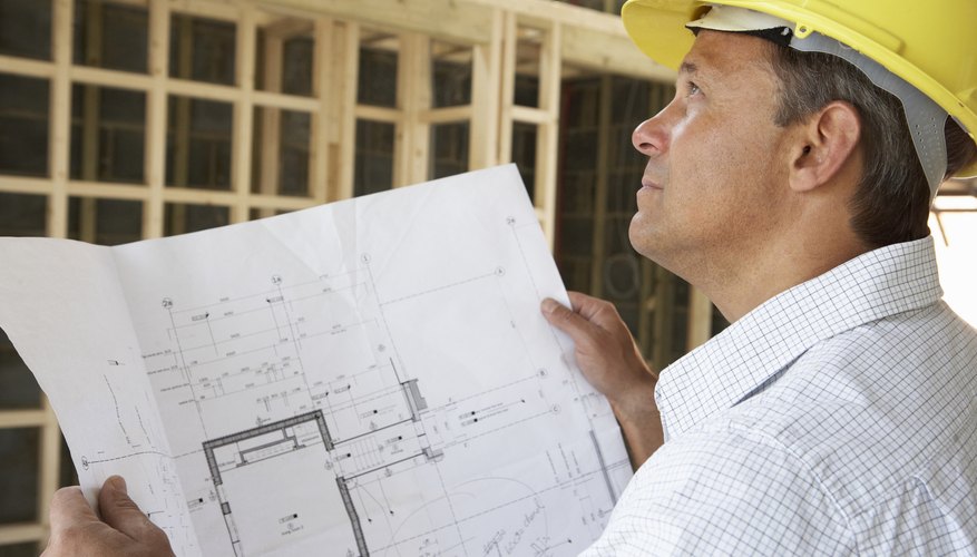 Architect With Plans In New Home