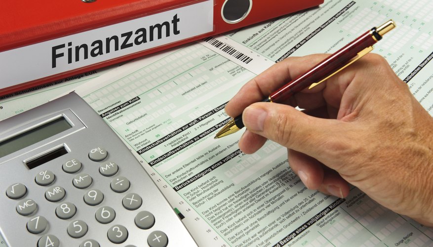A couple is filling out their tax forms with an accountant present.