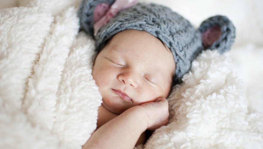 A portrait of a sleeping newborn wearing an elephant hat. A portrait of a sleeping newborn wearing an elephant hat.