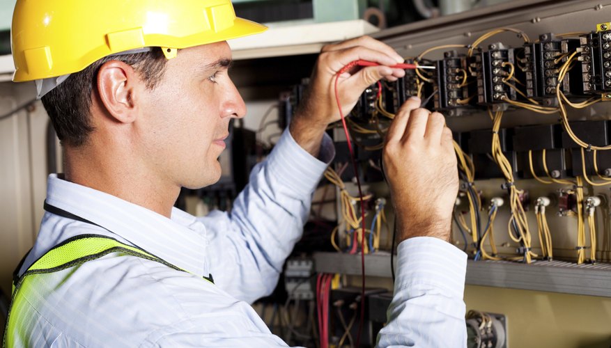 electrician testing industrial machine