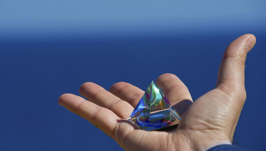 Hand holding crystal pyramid Hand holding crystal pyramid