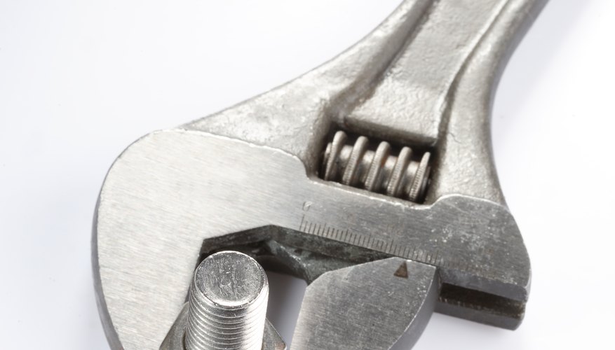 Close-up of a spanner, nut and screw