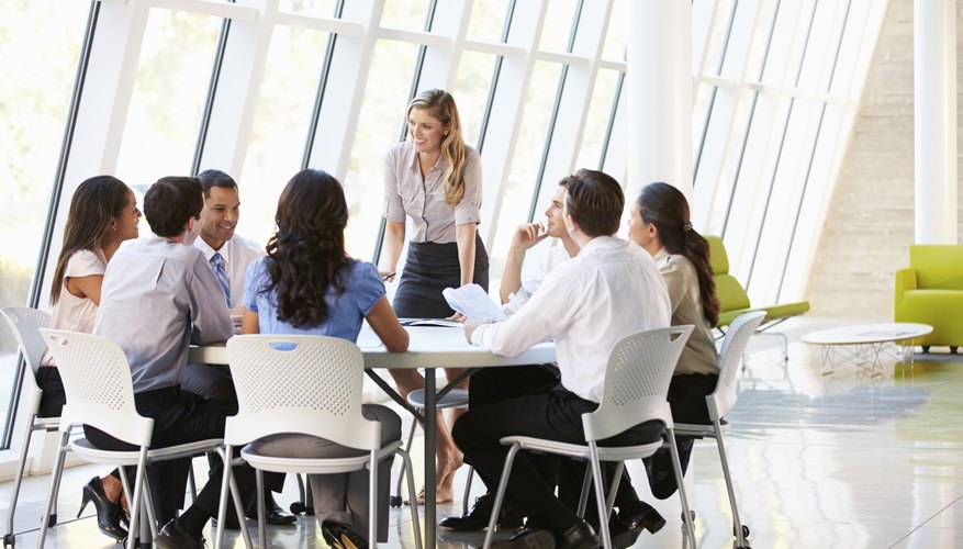 Photo Credit: Catherine Yeulet/iStock/Getty Images business having a team meeting