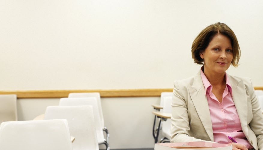 Woman working on review materials at desk.
