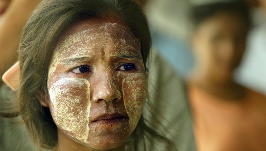 Burmese woman wearing yellow sandalwood paste on skin Burmese woman wearing yellow sandalwood paste on skin