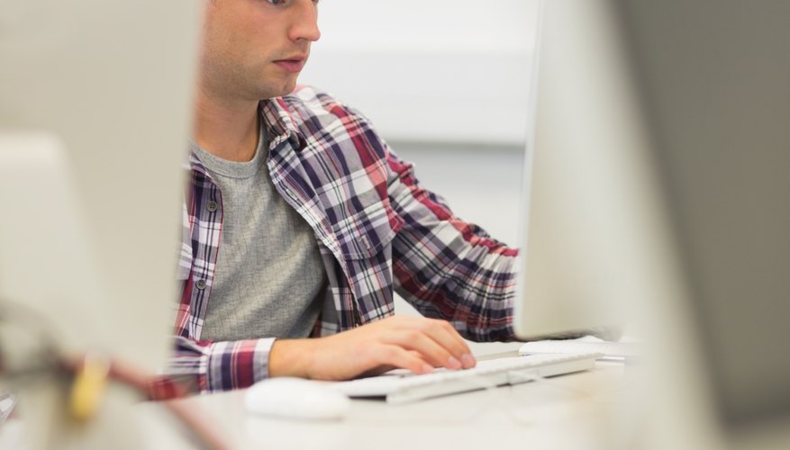 A college student is working in the computer lab.