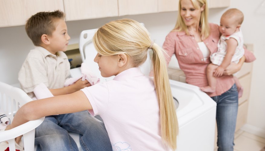 Teenage girl helping her family do laundry Teenage girl helping her family do laundry