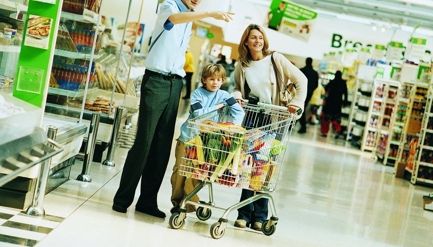 Shop Assistant Giving Advice to a Mother and Son in a Supermarket