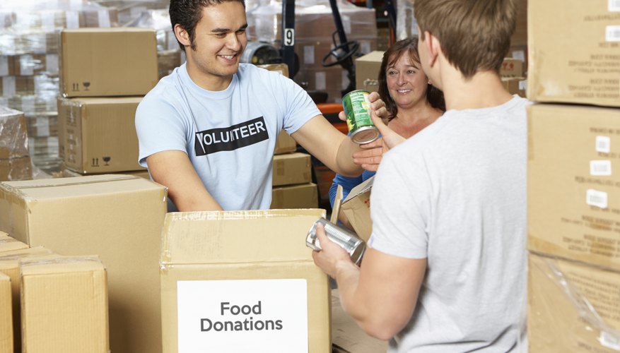 Volunteers Collecting Food Donations In Warehouse