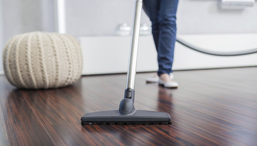 Woman vaccuming living room Woman vaccuming living room