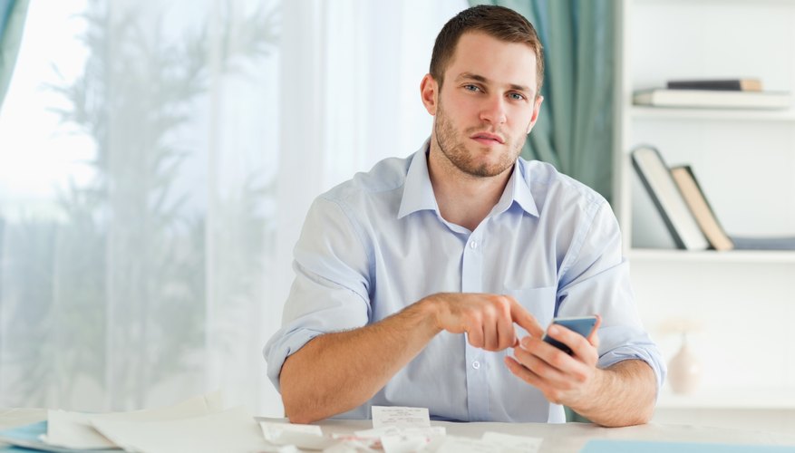 Businessman using his electronic calculator