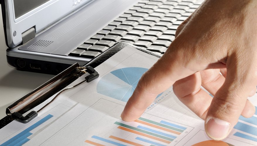 analyst pointing values on a graph