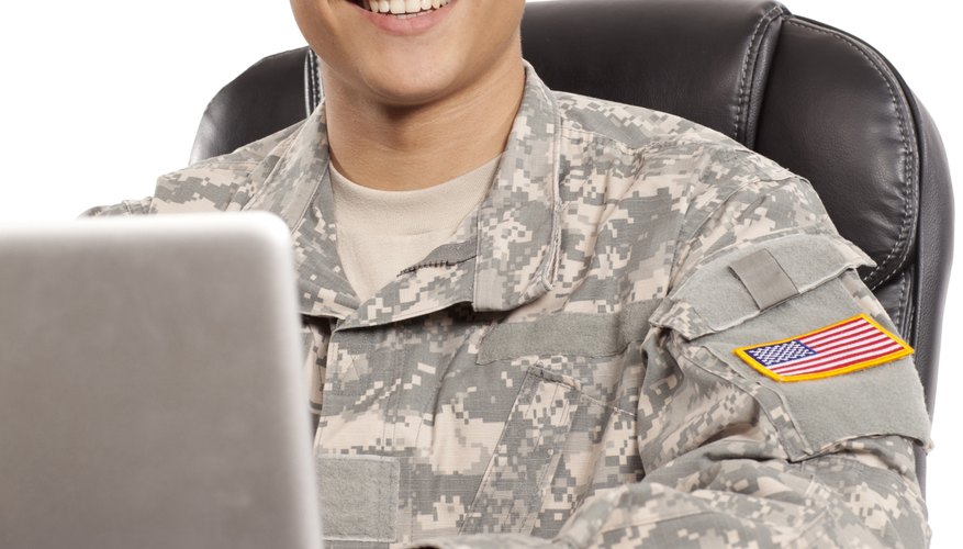 Smiling soldier works at his desk
