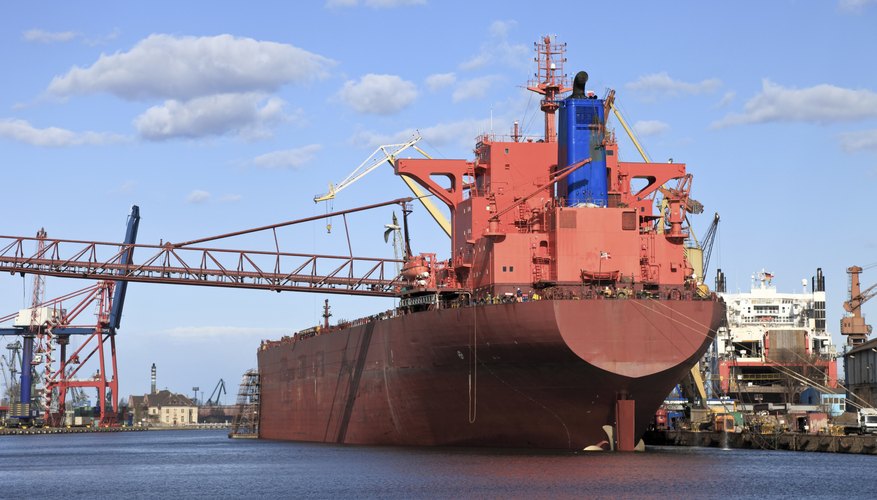 Photo Credit: nightman1965/iStock/Getty Images A large oil tanker departs a shipyard.