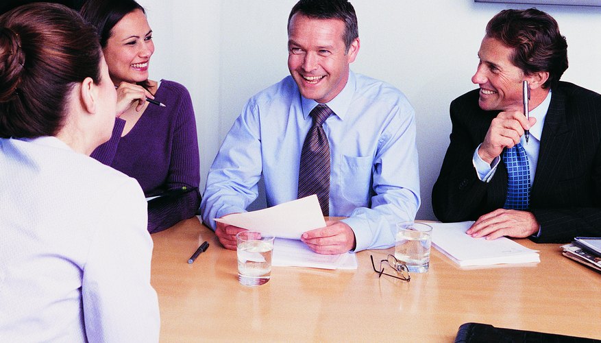 Photo Credit: Digital Vision./Digital Vision/Getty Images Man conducting interview