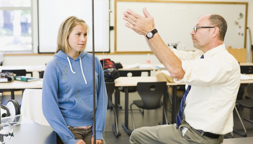 Photo Credit: Purestock/Purestock/Getty Images Professor explaining range to student in classroom