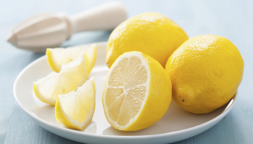 Photo Credit: OlgaMiltsova/iStock/Getty Images Sliced lemons on a plate.