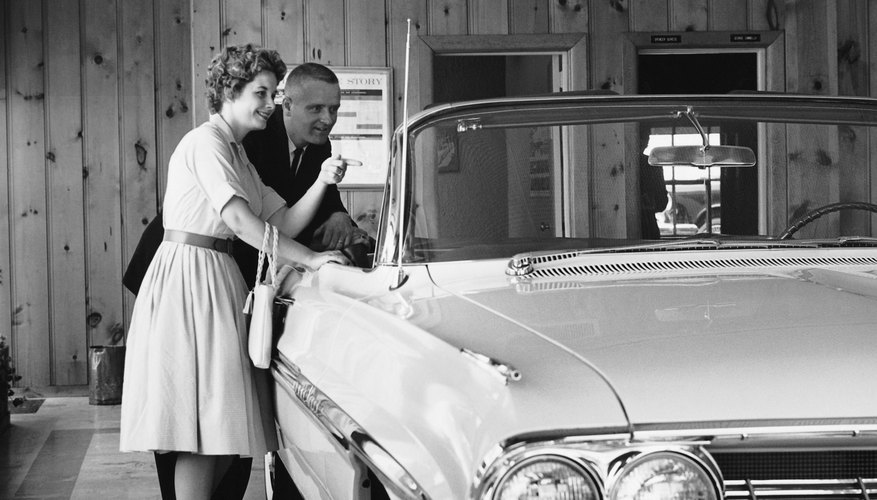 Couple looking at convertible in showroom