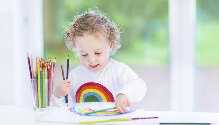 Young child playing with colored pencils Young child playing with colored pencils
