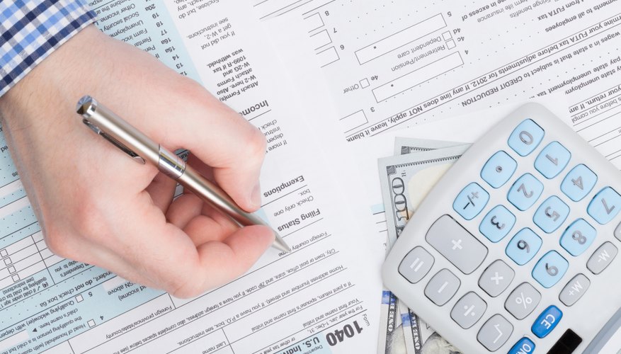 A man is filling out tax forms.