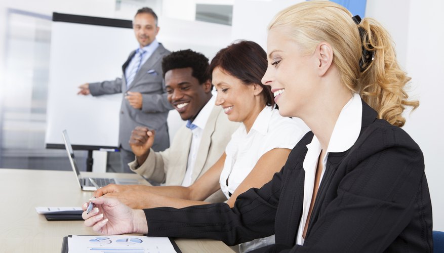 Business executives taking notes during a meeting