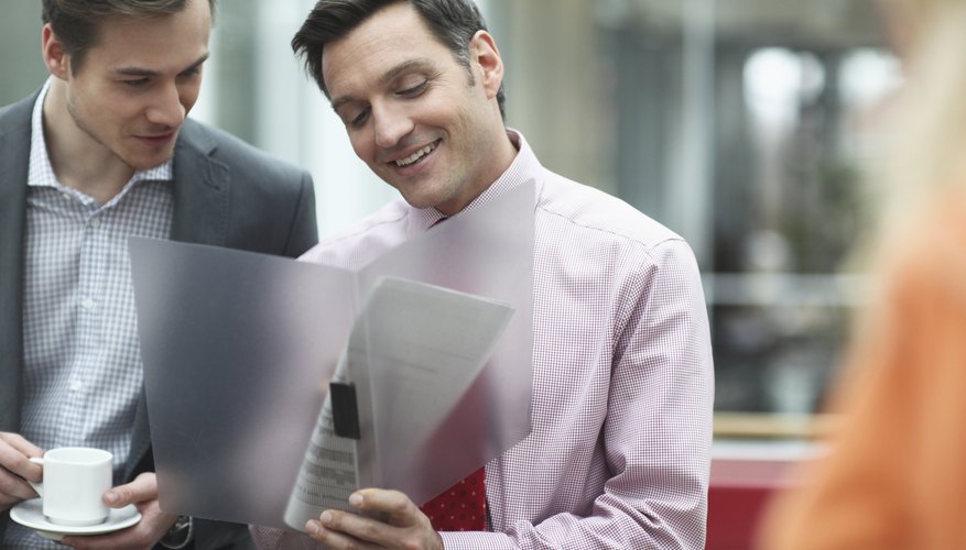 Business colleagues holding files in meeting