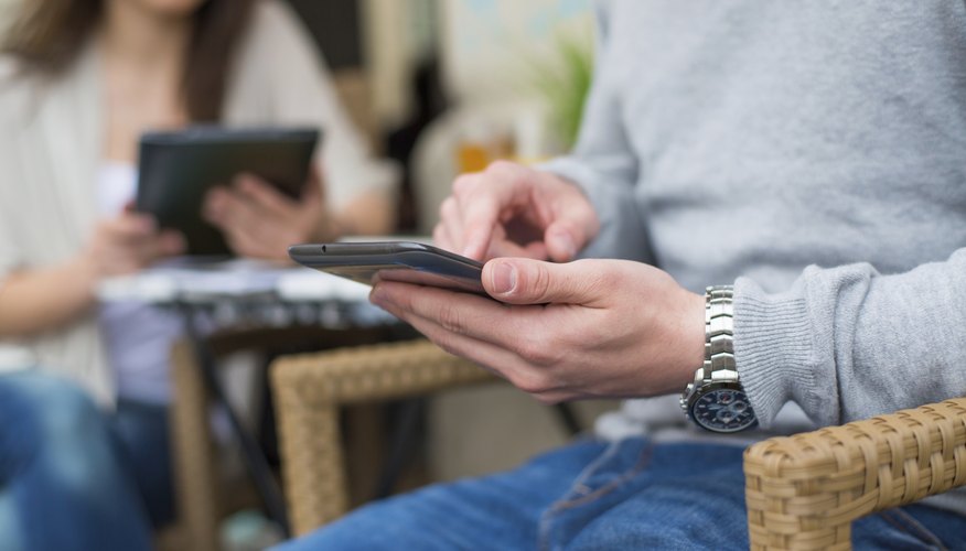 A man is checking something on his smarphone.