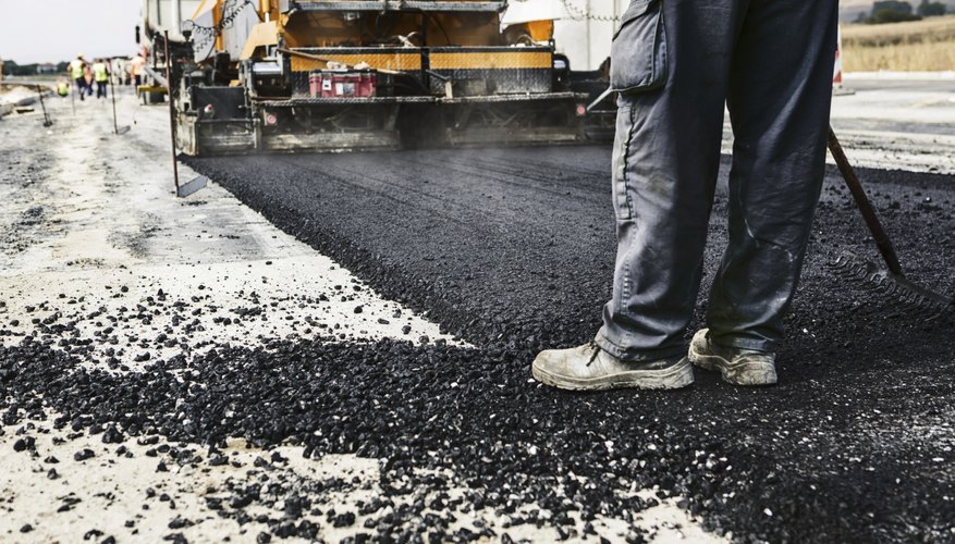Photo Credit: jocic/iStock/Getty Images Asphalt being laid for road construction.