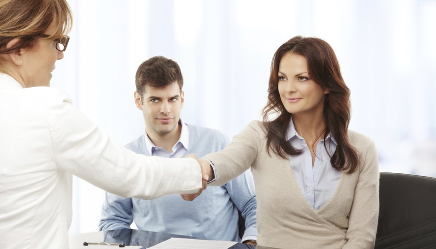 Woman shaking hands with debt collector