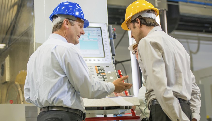Engineers Programming A CNC Machine
