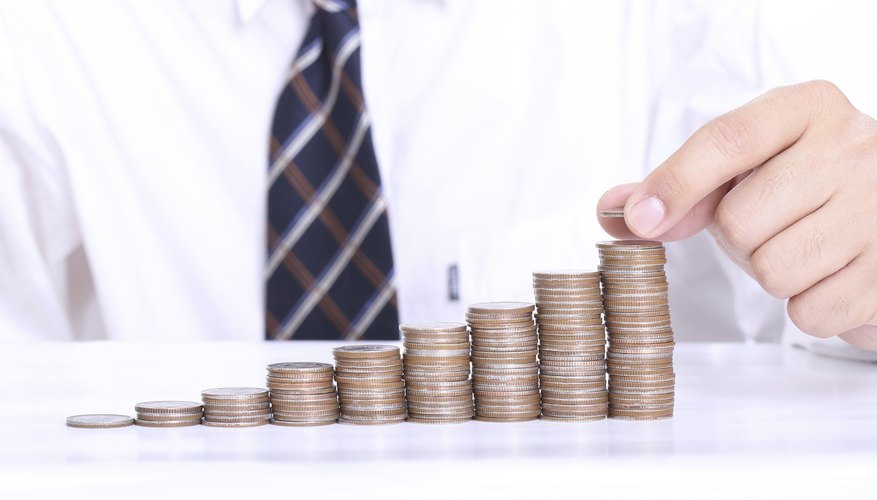 Close-up of man stacking coins