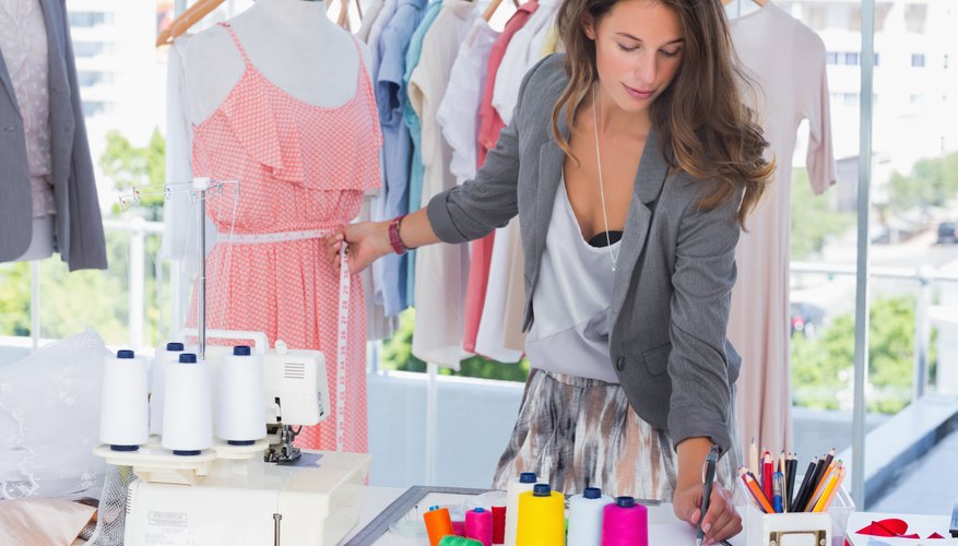 Fashion designer measuring a mannequin