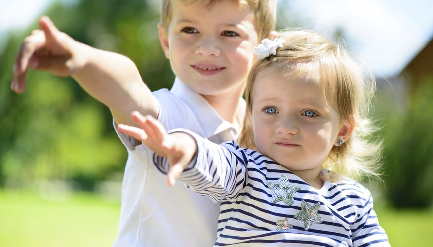 Two siblings pointing in the same direction. Two siblings pointing in the same direction.