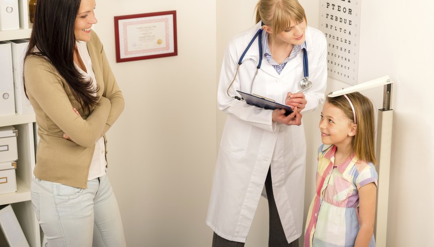 Photo Credit: CandyBox Images/iStock/Getty Images Pediatrician measuring girls height