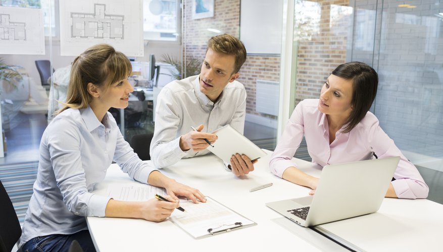 Start-up business team in meeting, working on computer